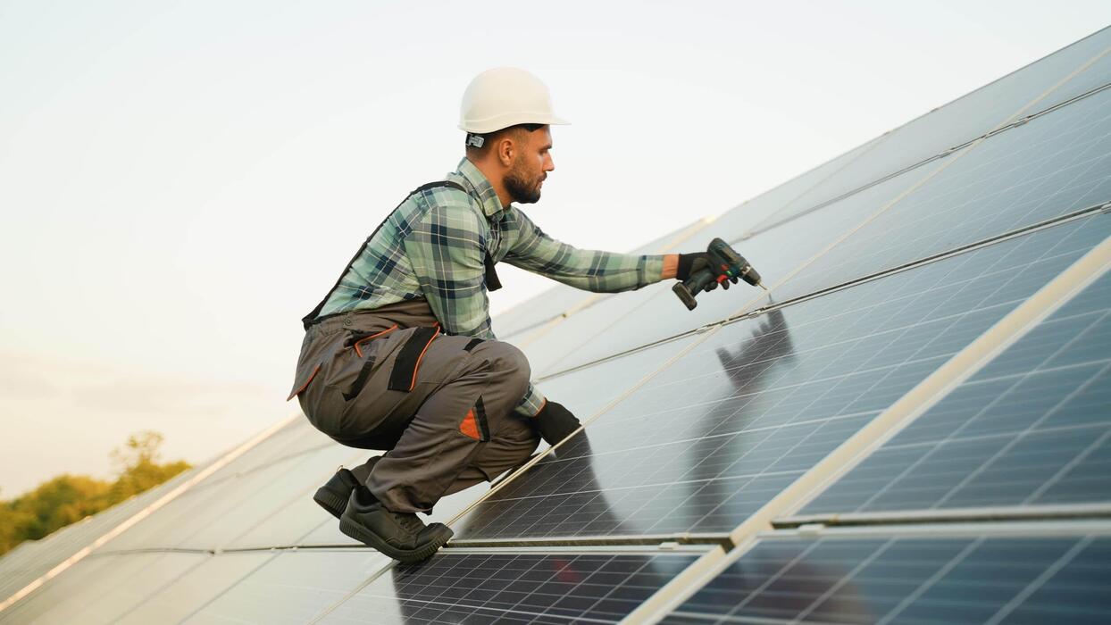 technician installing solar panels on a roof video